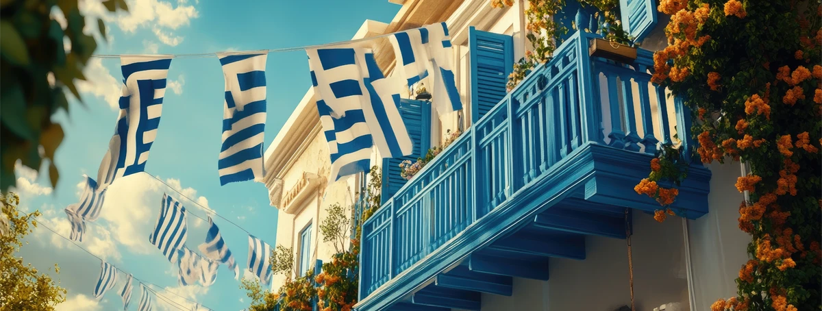 Greek flags hanging from balcony
